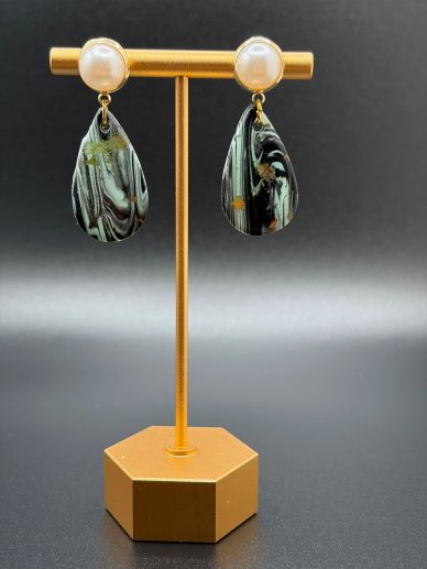 Pearl and marble teardrop earrings on a gold stand.