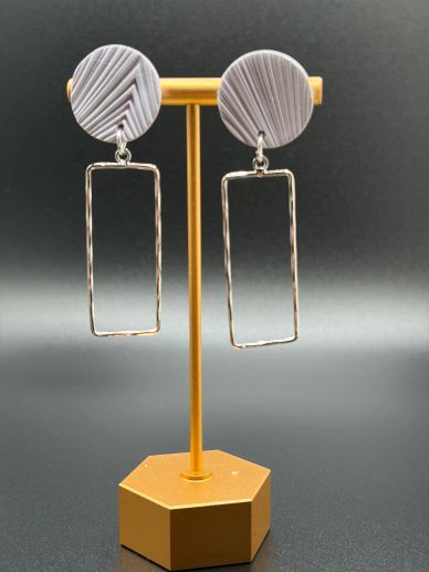 Modern geometric earrings with circular tops and rectangular hangs.