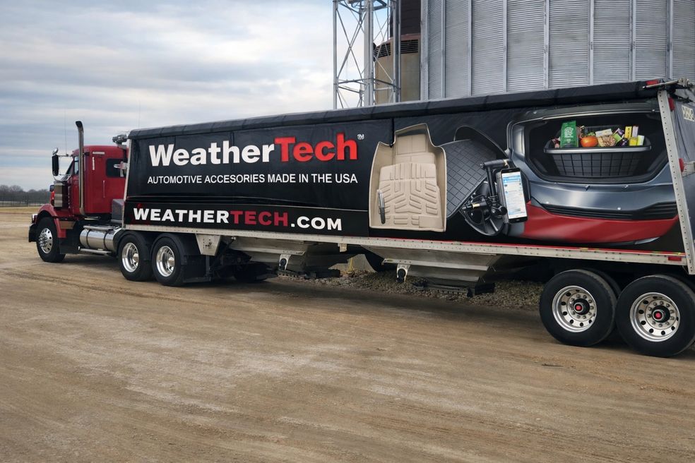 Red hopper truck with ad