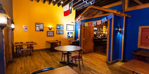 Long view of a restaurant with tables and chairs