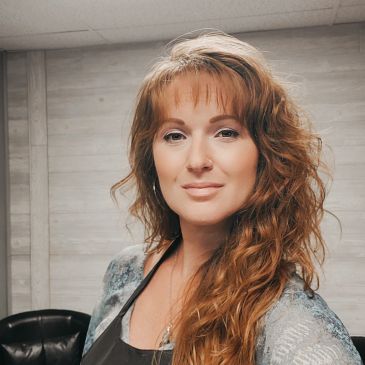 Portrait of a woman with long wavy hair.