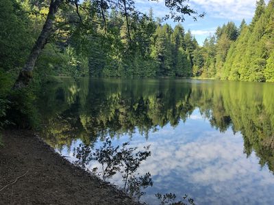 Trees and sky reflected on Fragrance lake. 