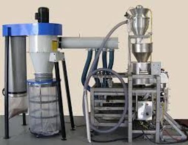 Industrial powder processing equipment with connected tubes and collection bags.