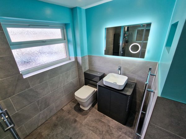 Half tiled Bathroom installation 
Shower, basin unit, toilet, towel radiator, LVT floor