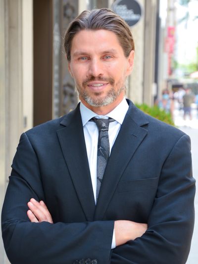 Confident man in a suit outdoors.
