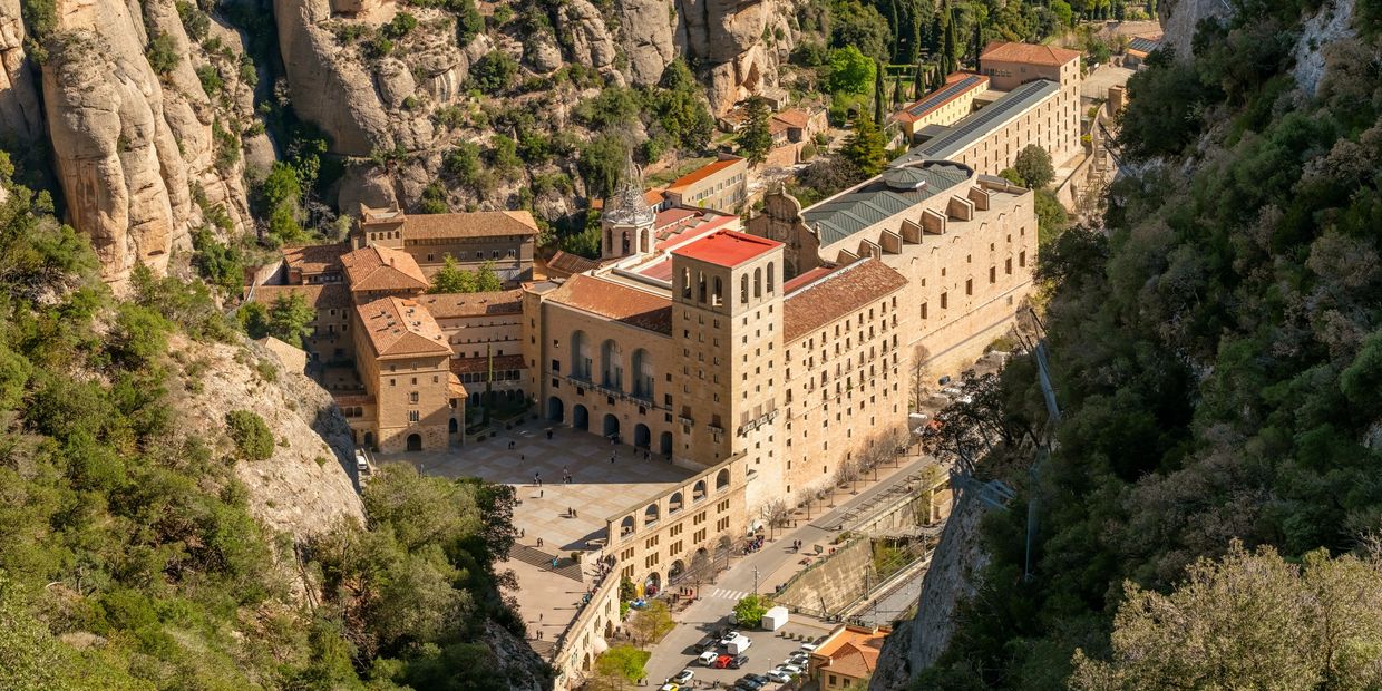 Historic monastery nestled in rugged mountainous terrain.