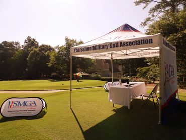 Tent setup for The Saline Military Golf Association at a golf course.