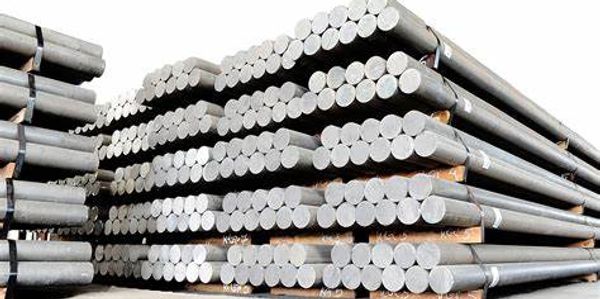 Stacked metal rods arranged in piles.