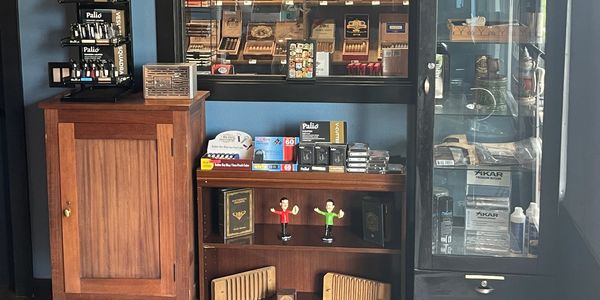 Wooden cabinet and display case with cigars and accessories.
