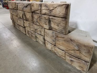 Stack of rustic wooden blocks arranged indoors.