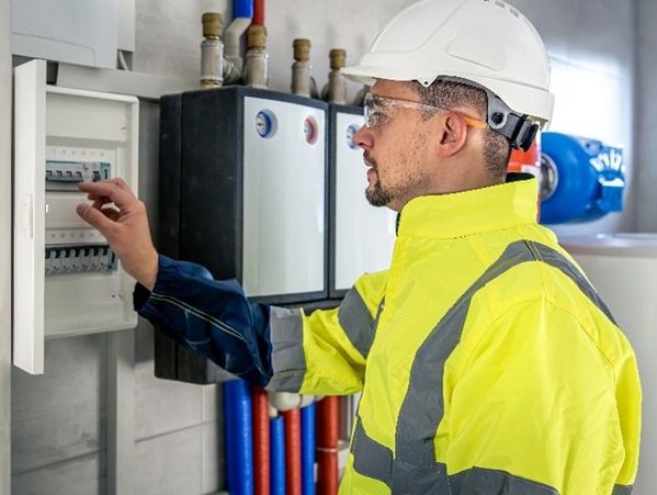 Technicians performing Furnace Repair in Lakeland by servicing an outdoor HVAC unit for reliable win