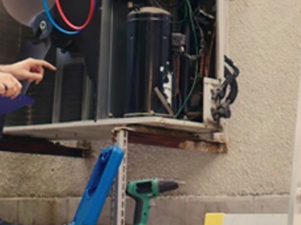 Technicians performing Furnace Repair in Marine on Saint Croix by servicing an outdoor HVAC unit for