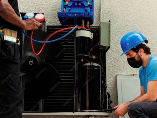 Technicians performing Furnace Repair in Newport by servicing an HVAC unit for fast reliable heating