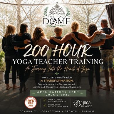 Group embracing under The Yoga Dome logo for teacher training.