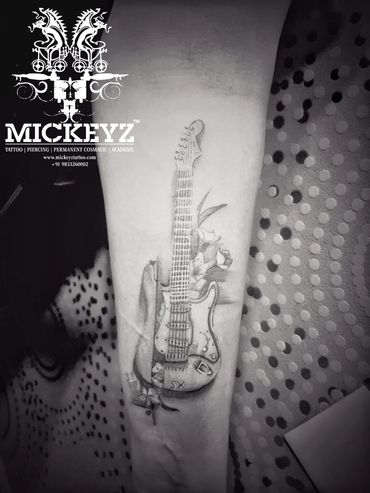 Beautiful guitar forearm tattoo inked at Mickeyz Tattoo Studio, the best tattoo studio, Mumbai