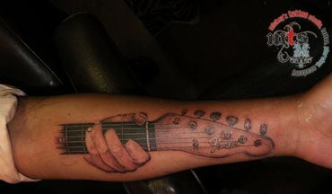 Custom guitar tattoo inked at Mickeyz Tattoo Studio, the best tattoo studio, Mumbai