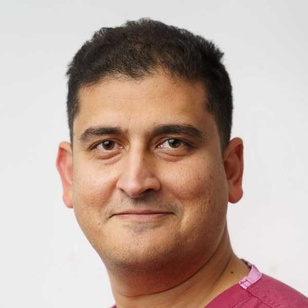 Portrait of a man with short dark hair and a slight smile.