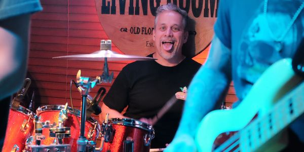 Drummer making a funny face during a performance.