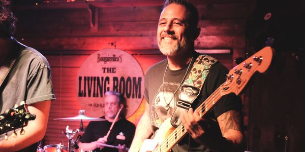 Musicians playing live at The Living Room venue.