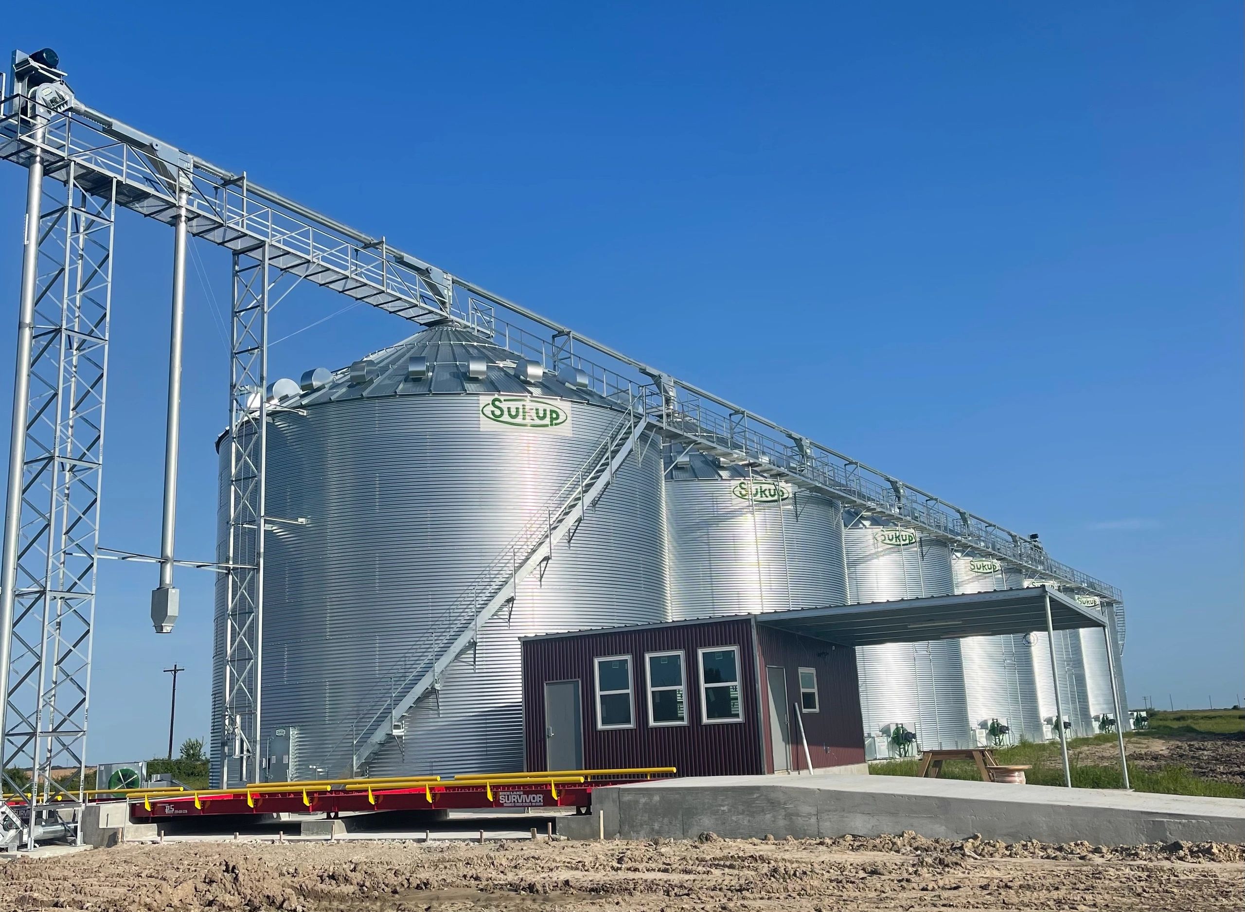 Grain bin loop system with electrical building and scales 