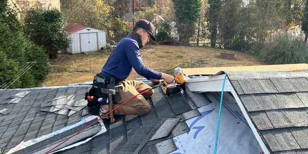 a man repairing roof of a house 