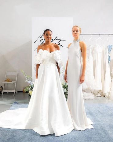 Two models in stunning white wedding gowns.