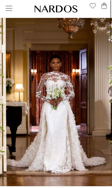 Bride in an elegant lace wedding gown holding a bouquet.