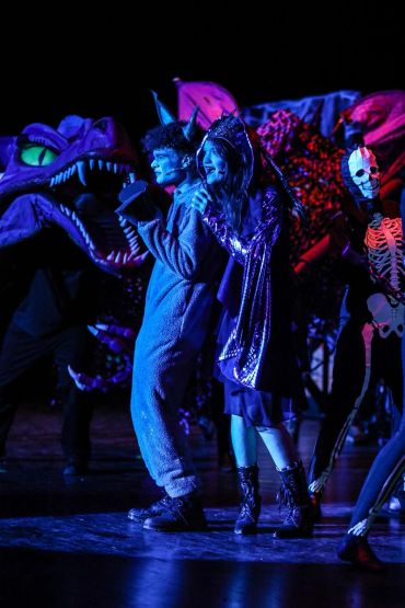 Actors in colorful costumes during a theatrical performance.