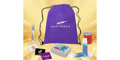 Purple LA Fitness drawstring bag with assorted branded items on a golden background.