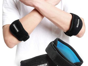 Adjustable black elbow supports worn on both arms.