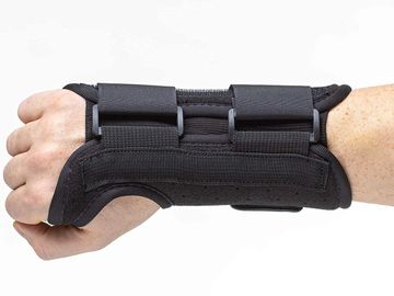 A black wrist brace on a person's hand.