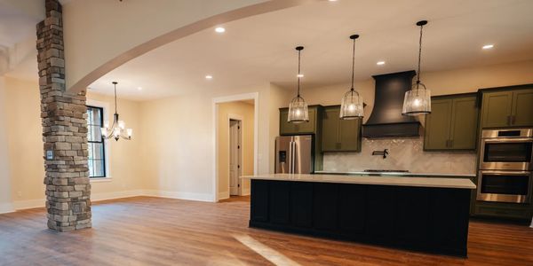 Remodeled kitchen with green cabinets. 