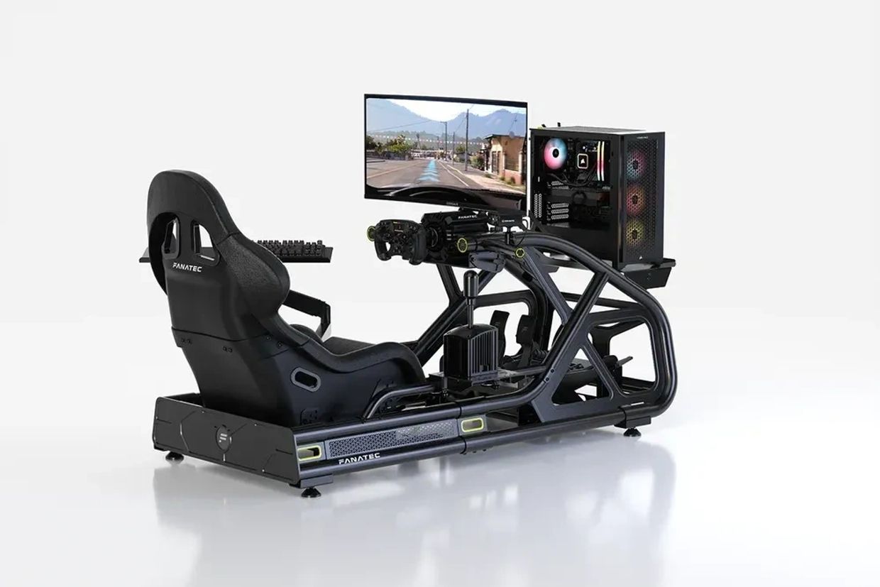High-end racing simulator setup with seat, steering wheel, pedals, monitor, and PC.