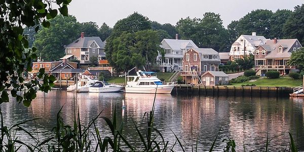 Waterfront houses with boats docked along the shore.