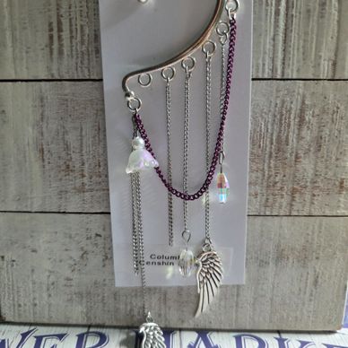Elegant silver ear cuff with dangling charms and purple chain.