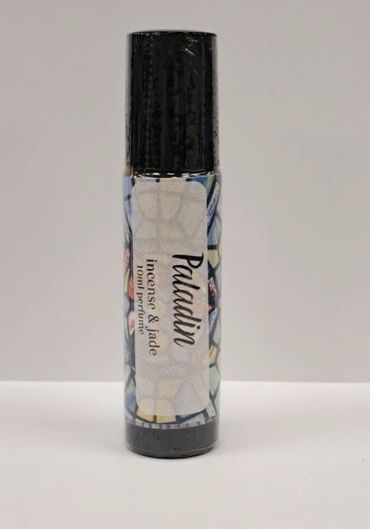 A bottle of Paladin incense and jade tone perfume with a black cap.