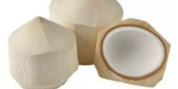 Three peeled coconuts, one cut open showing white flesh inside.
