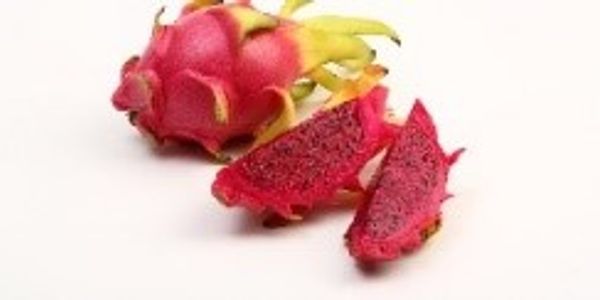 Bright pink dragon fruit with slices showing vibrant red flesh.