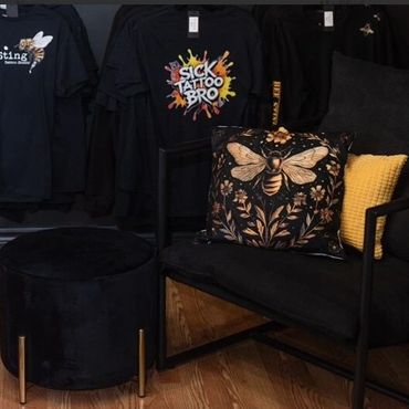 Cozy black seating area with bee-themed pillow and yellow cushion.