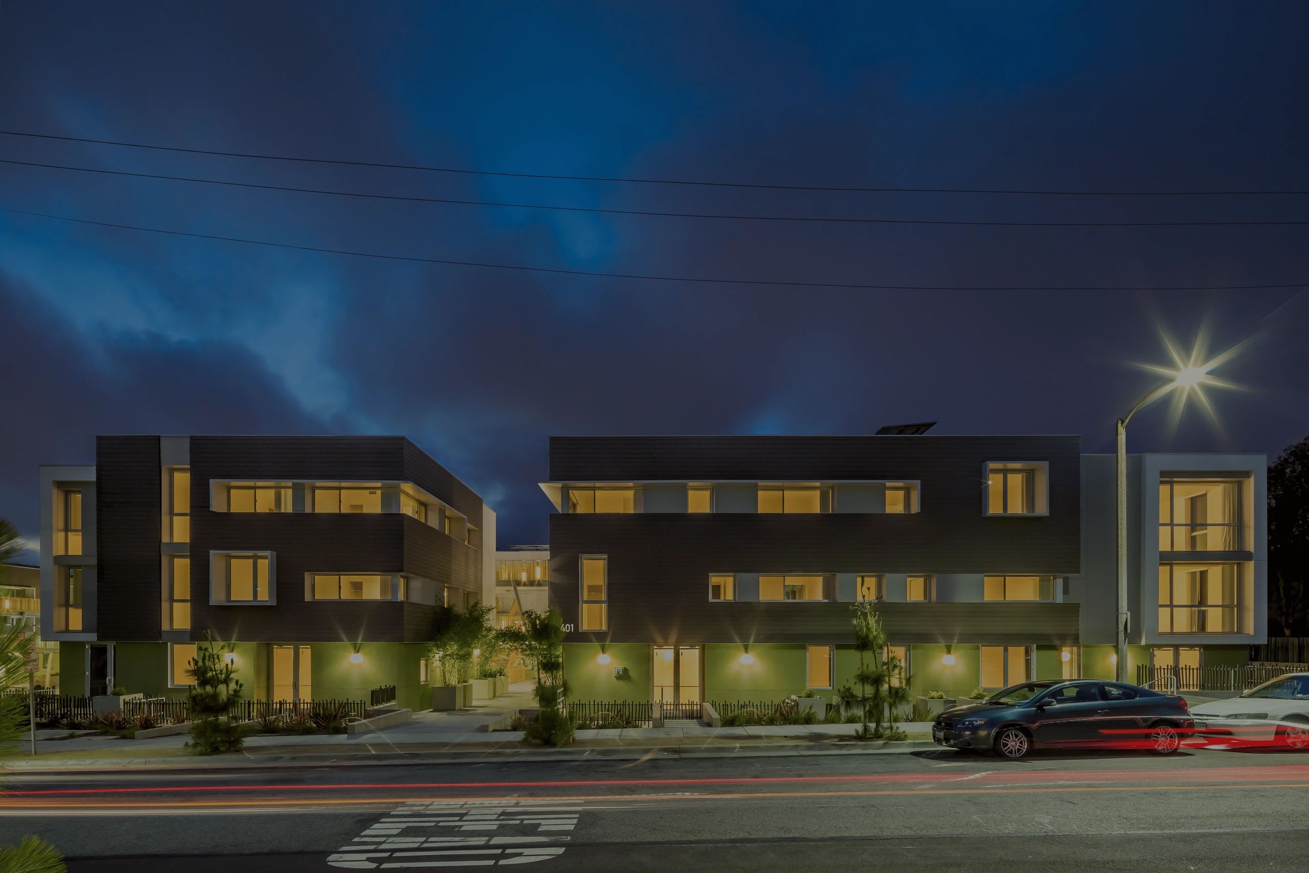 Modern buildings illuminated at night.