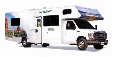 White motorhome RV with scenic desert graphics on the side.