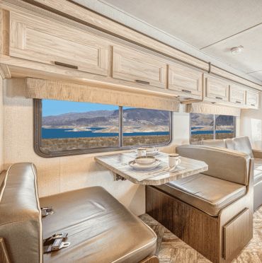 Cozy RV dining area with scenic lake view.