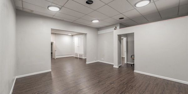 Empty room with wooden floor and white walls.