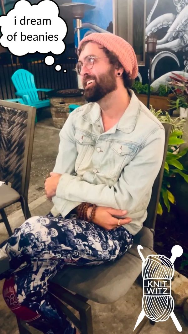clark ogier sitting in a chair smiling with a thought bubble saying, "i dream of beanies"