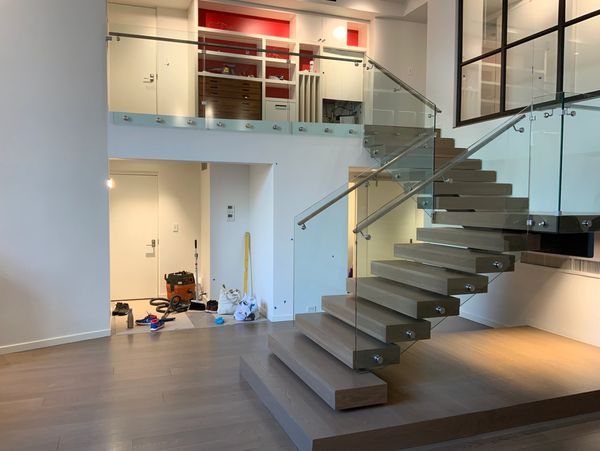 job completed with new york wood stairs showcasing floating treads and glass and steel railings