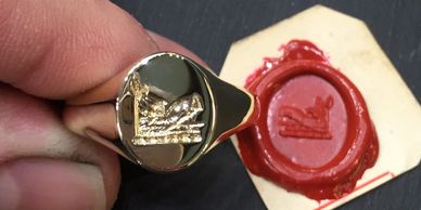 Gold seal engraved on a signet ring and a wax impression 