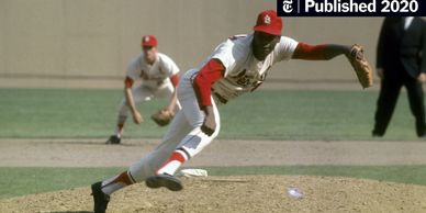 Baseball pitcher in mid-throw on the mound.