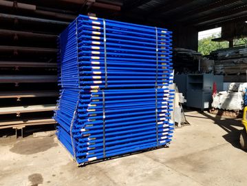Stacked blue metal frames in a warehouse.