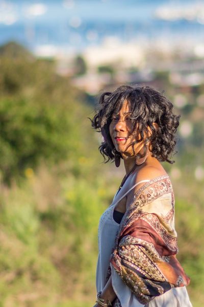 Image of Joi Gayles standing on vista of Sausalito Bay. Her hair treated with herbal hair tonic. 