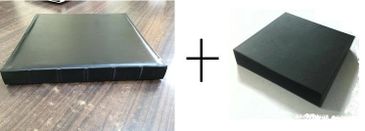 A leather-bound book and a black box side by side with a plus sign.